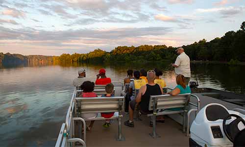 Passengers njoying a pontoon boat tour at Trap Pond State Park