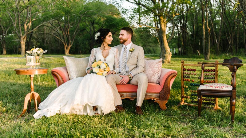 bride and groom sitting at a picnic table